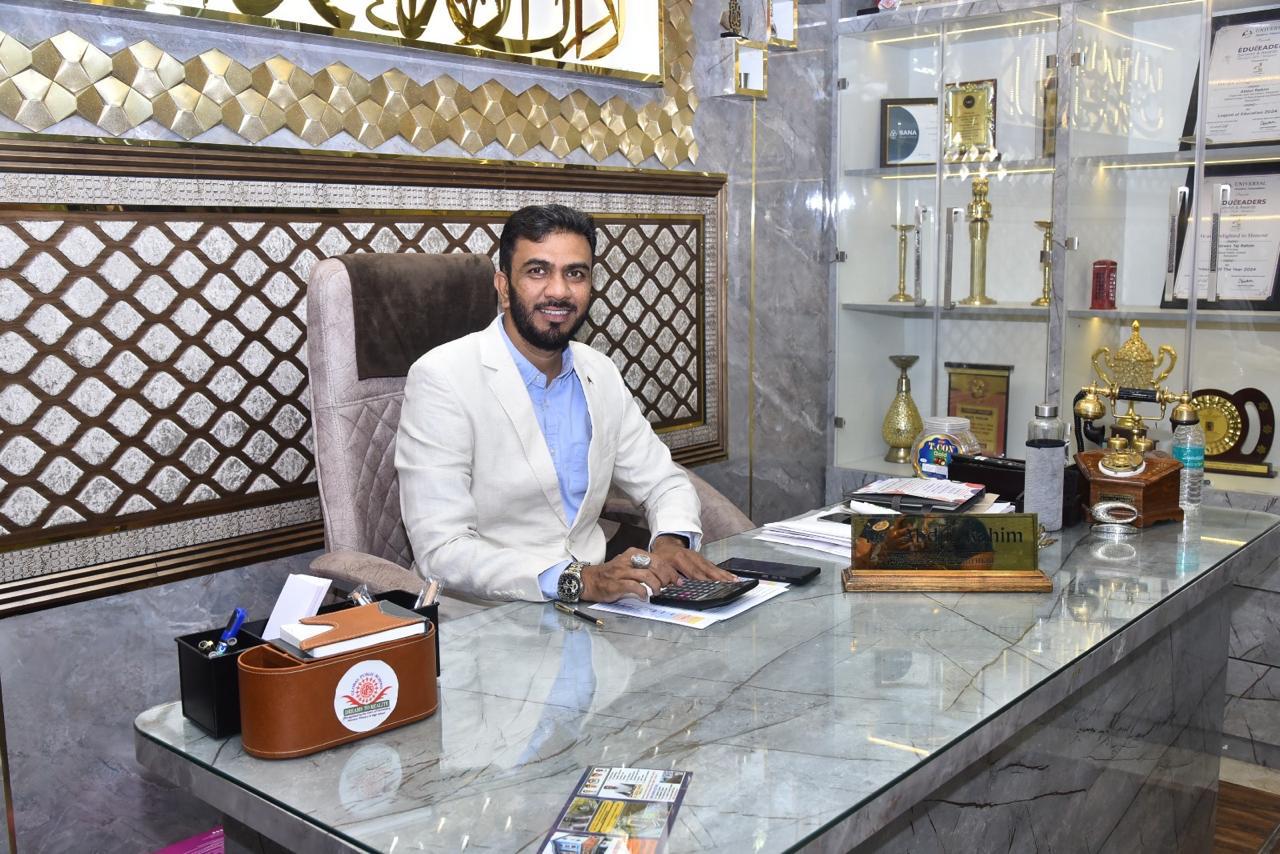 Principal seated at the office desk