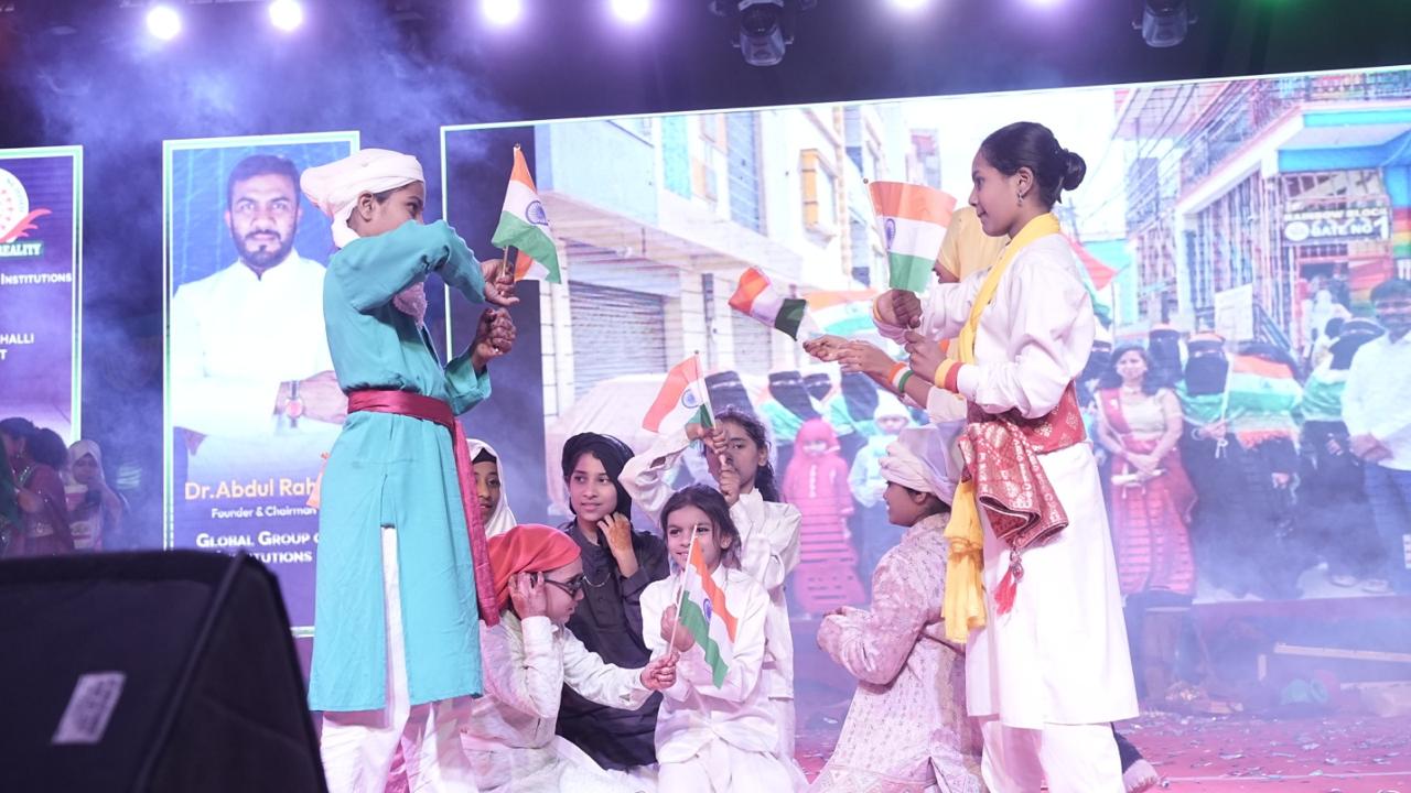 Children in a patriotic dance with Indian flags
