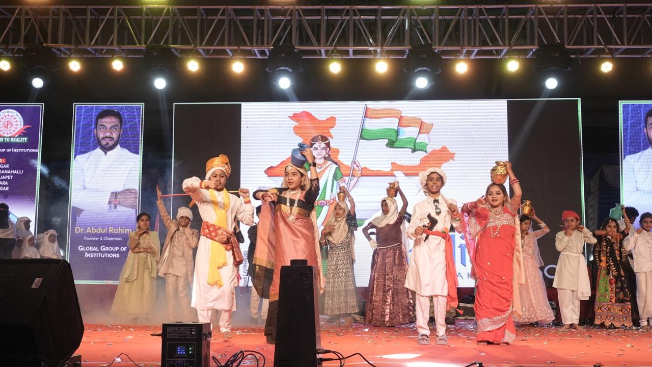 Children in cultural costumes performing on stage