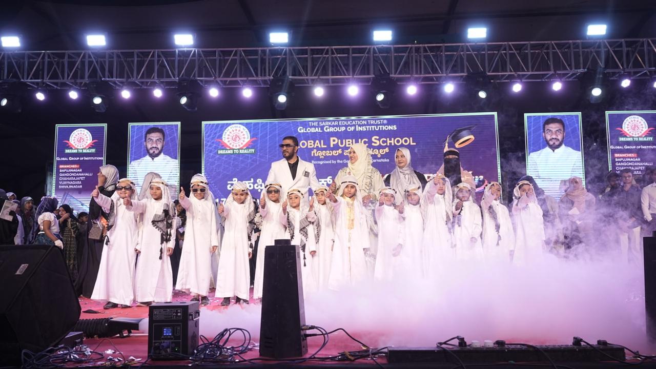 Young children in white attire on stage