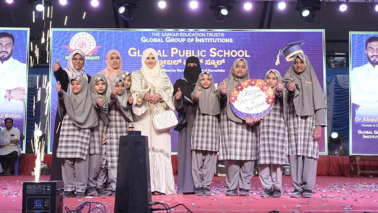 Students with teachers holding a decorated sign