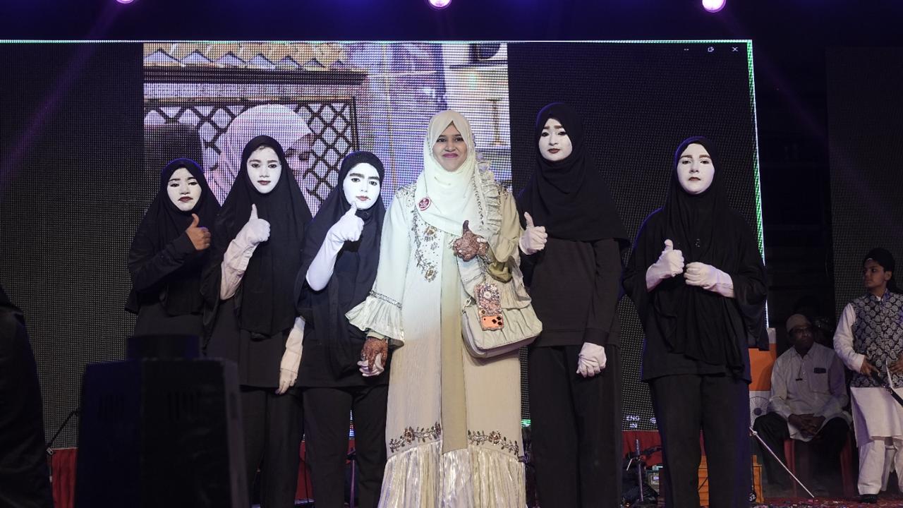Students pose with their teacher after a performance
