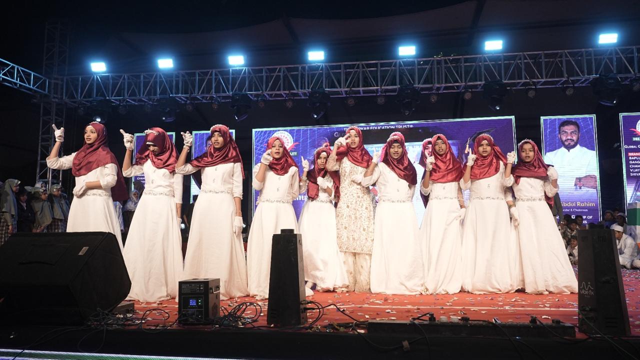 Girls in white perform a stage dance
