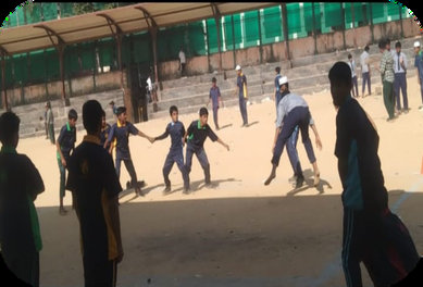 Students playing football outdoors